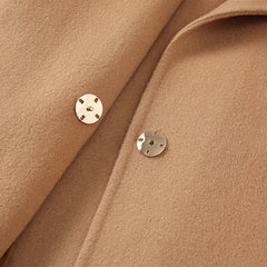 Close-up of a brown fabric with two gold buttons.