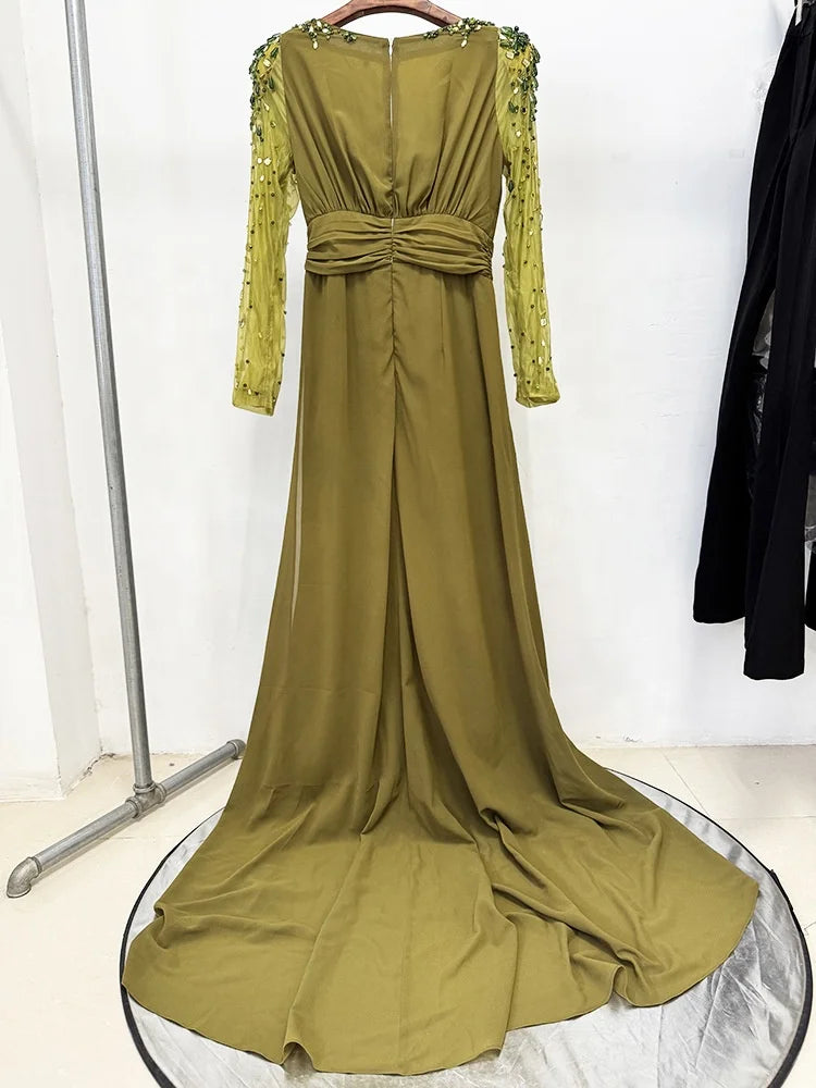 Green evening gown with lace sleeves on a white background