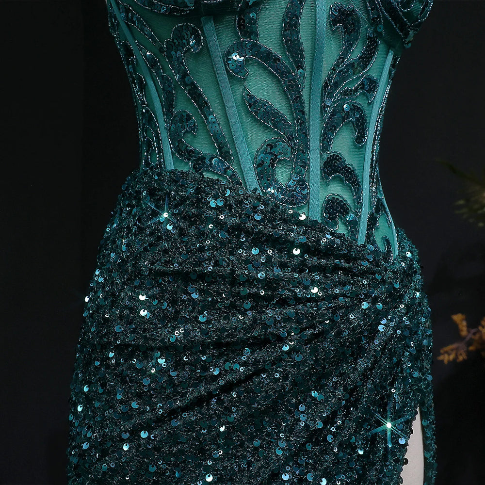 Close-up of a teal evening gown with intricate detailing and sequins on a black background