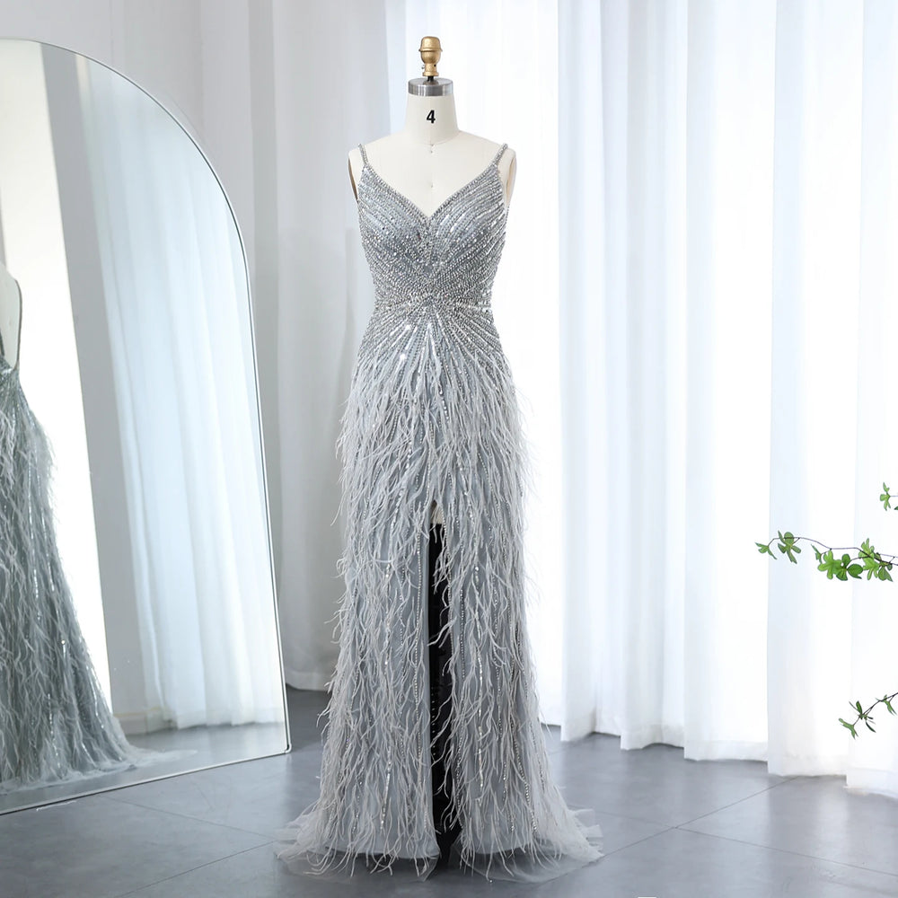 Silver beaded evening gown on a mannequin against a white curtain background