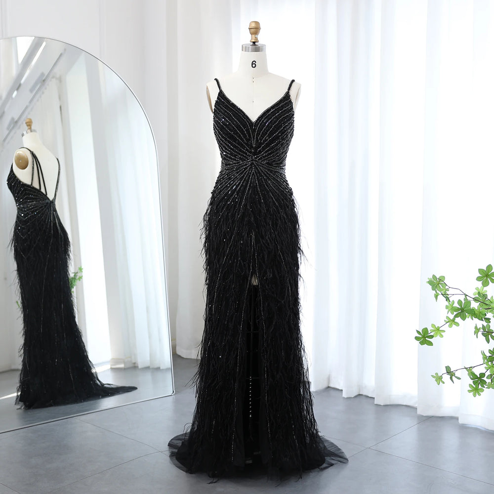 Black beaded evening gown on a mannequin against a white curtain background
