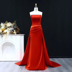 Red evening gown on a mannequin against a black background