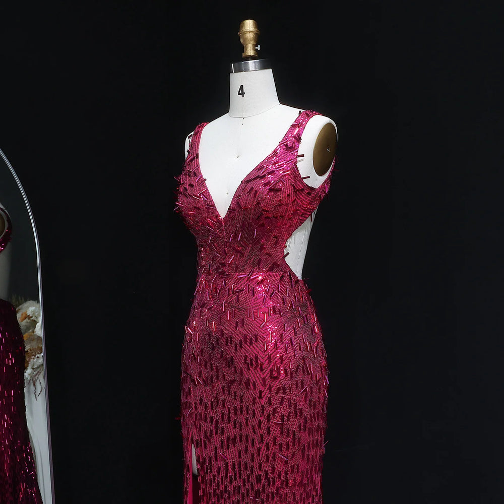 Pink sequin dress on a mannequin against a black background
