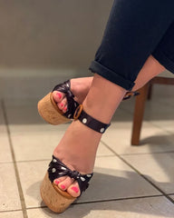 Close-up on polka dot platform wedge sandals toe detail