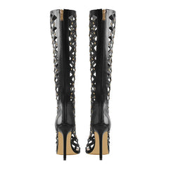 Back view of cutout studded stiletto knee-high boots