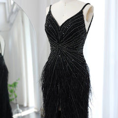 Black beaded evening gown on a mannequin against a white background