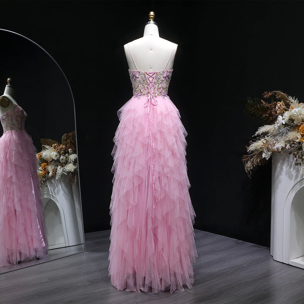 Pink evening gown on a mannequin with a dark background