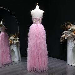 Pink evening gown on a mannequin with a dark background