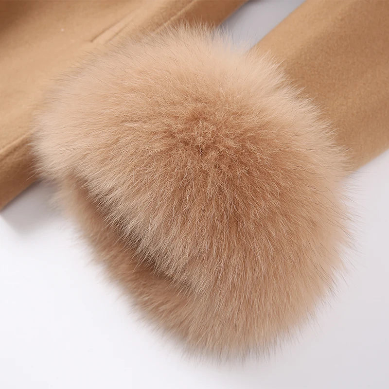 Close-up of a brown fur pom-pom on a beige fabric background