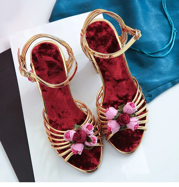 Close-up of floral embellishments on velvet heels