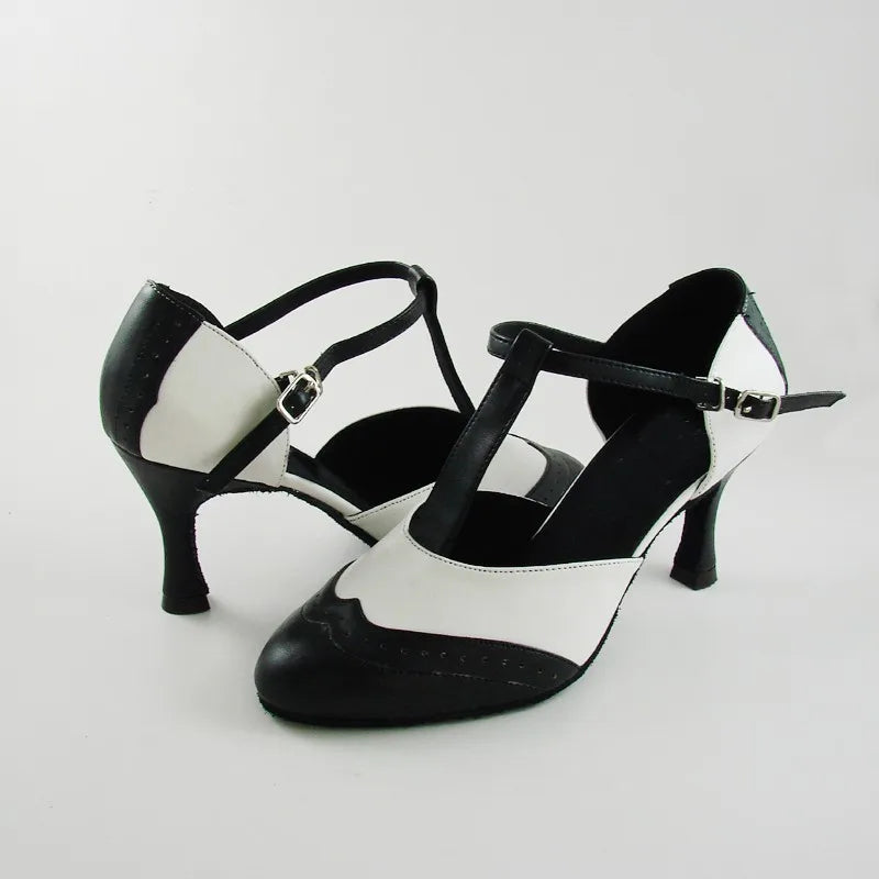 Pair of black and white T-strap dance heels shown from the side