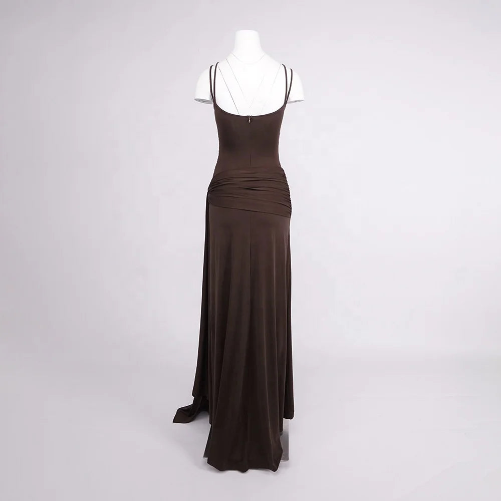 Brown evening gown on a mannequin against a white background