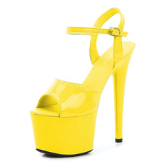 Yellow high-heeled platform shoe on a white background