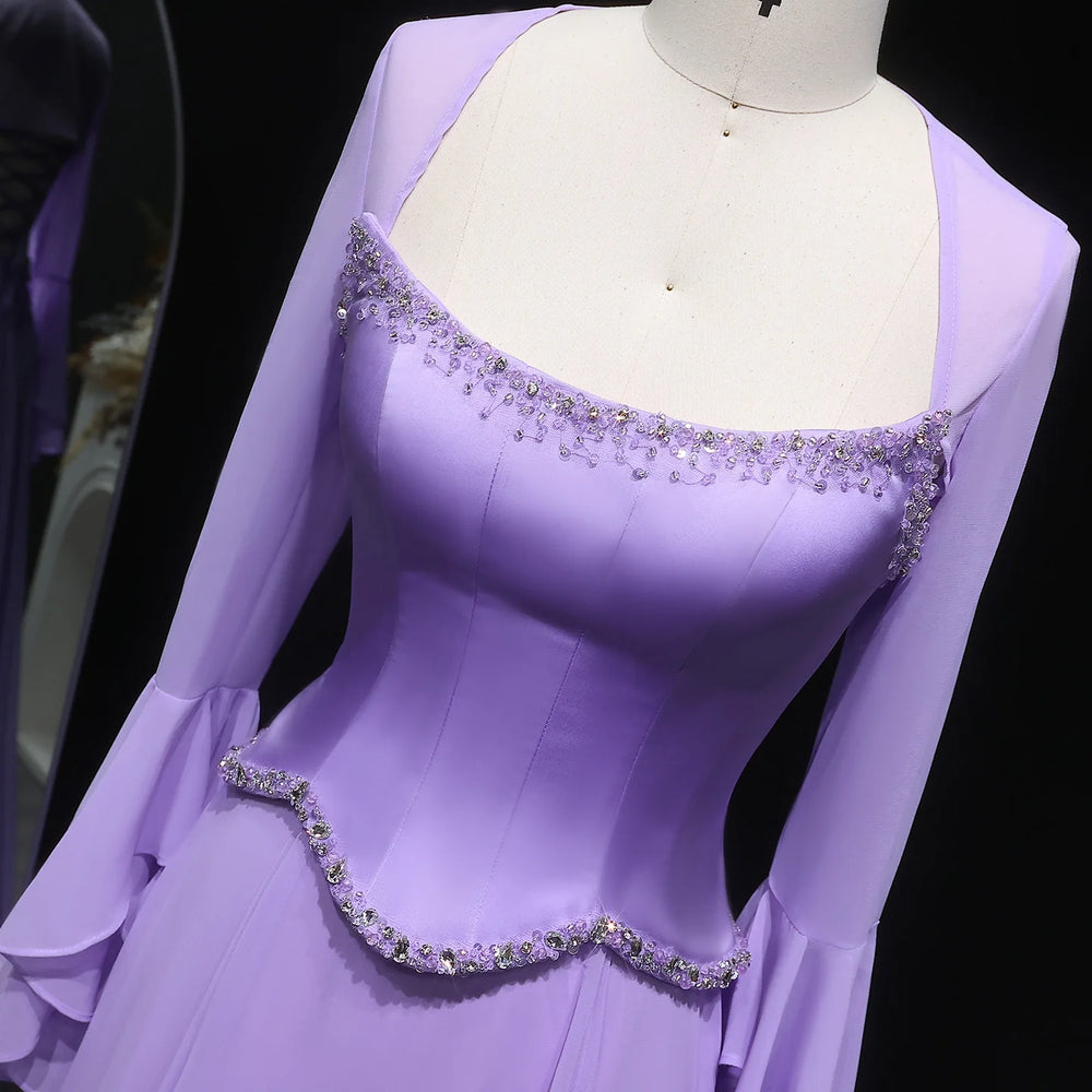Purple evening gown with embellishments on a mannequin against a dark background