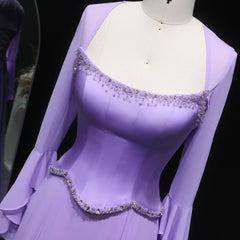 Purple evening gown with embellishments on a mannequin against a dark background