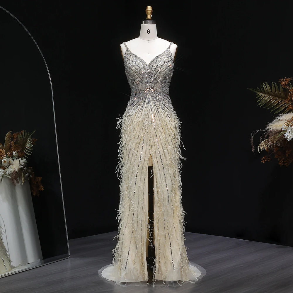 Elegant evening gown with feather details on a mannequin against a dark background