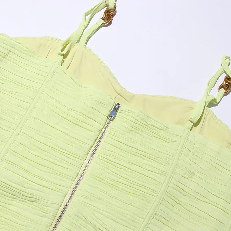 Light green textured top with a zipper on a white background