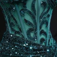 Close-up of a teal dress with black sequin detailing