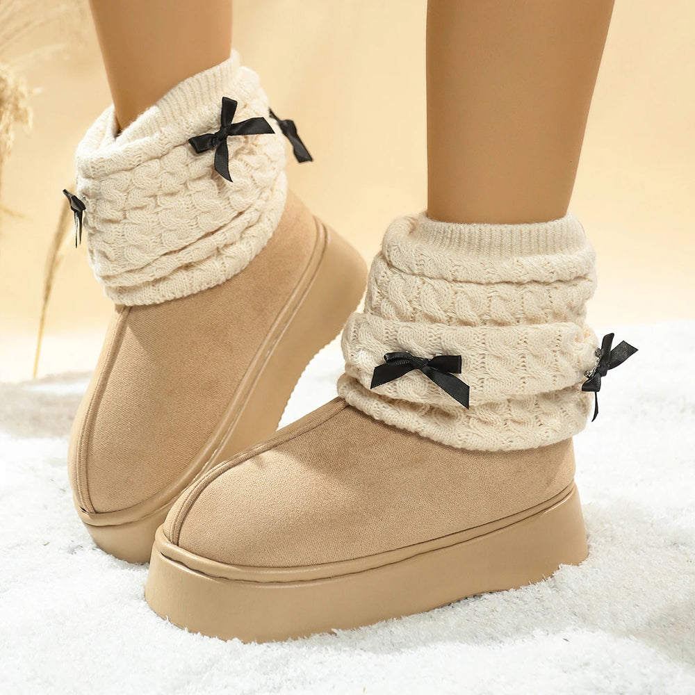 Beige winter boots with knitted leg warmers and black bows on a beige background