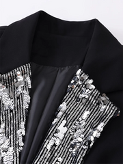 Black garment with silver sequin detailing on a white background