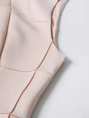 Close-up of a beige sleeveless top with a plain background