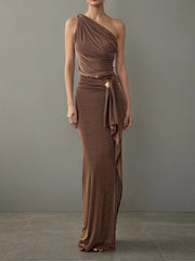 Woman wearing a brown one-shoulder dress against a gray background