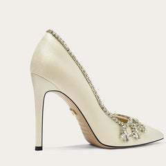 Elevated cream high heel with embellishments on a white background