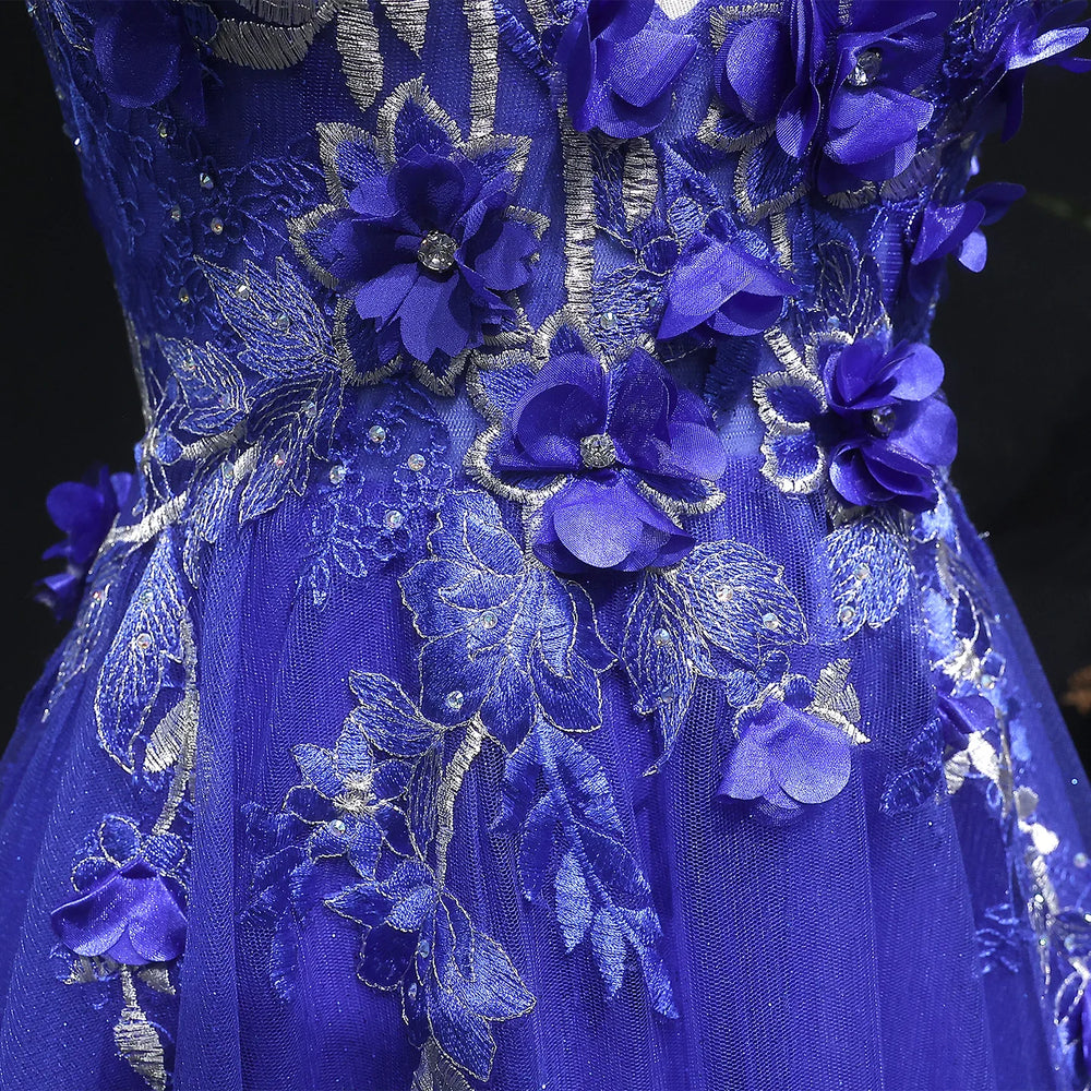 Close-up of a blue floral embroidered dress with intricate details.