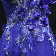 Close-up of a blue floral embroidered dress with intricate details.