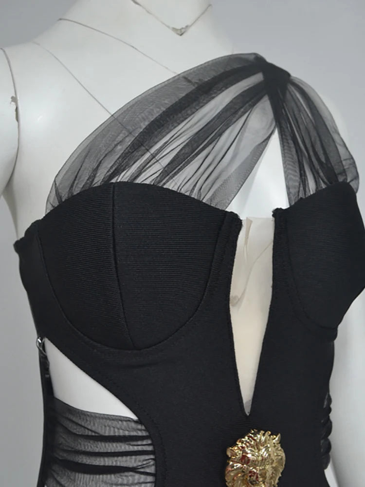 Black dress with sheer overlay on a mannequin against a gray background