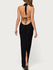 Black halter neck dress with a tie back detail on a white background