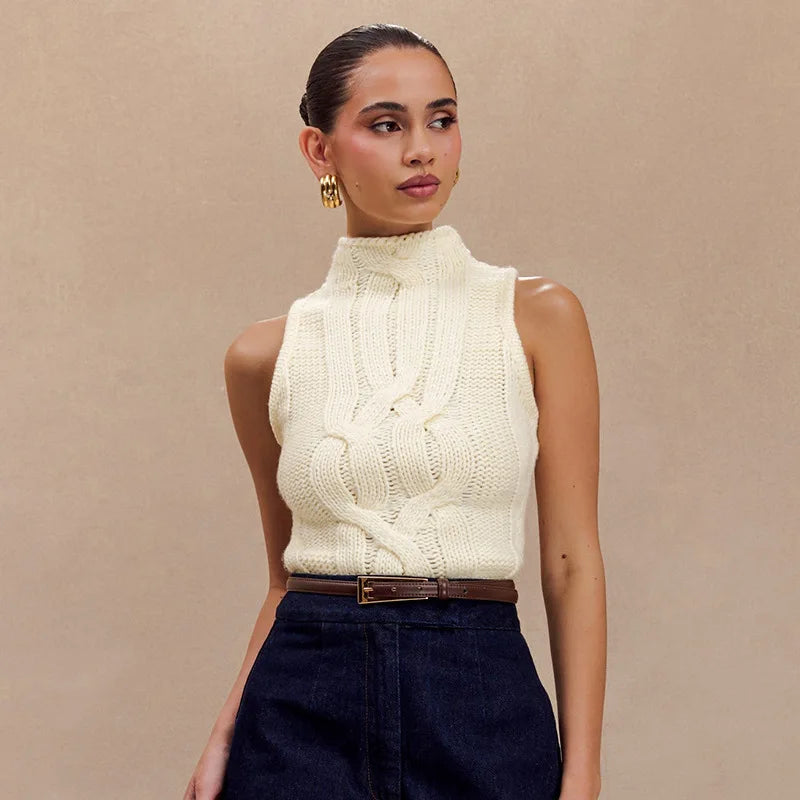 Woman wearing a cream knitted sleeveless top against a beige background