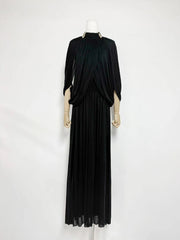 Black evening gown on a mannequin against a white background