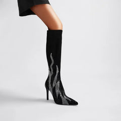 Black knee-high boot with silver flame design on a gray background