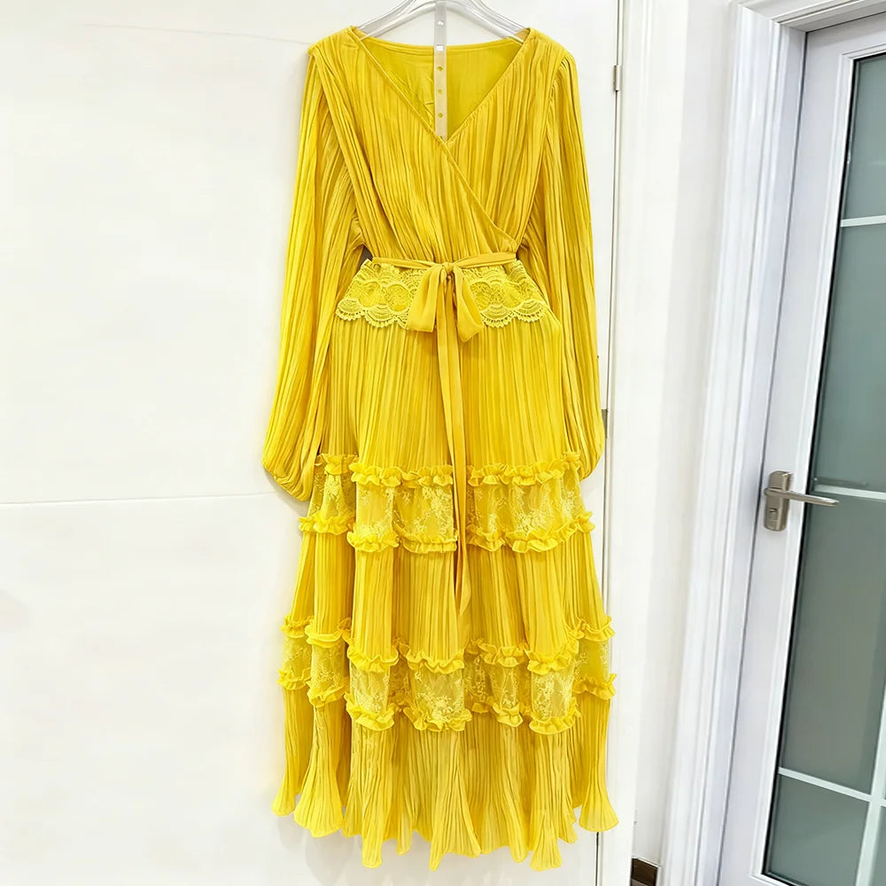 Yellow dress with lace details hanging on a white door