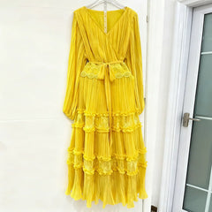 Yellow dress with lace details hanging on a white door