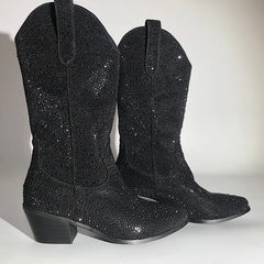 Close-up of embellished western boots highlighting the intricate rhinestone pattern.