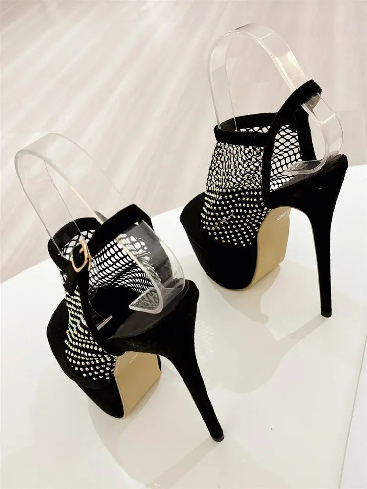 Black high-heeled shoes with mesh design on a white background
