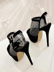 Black high-heeled shoes with mesh design on a white background