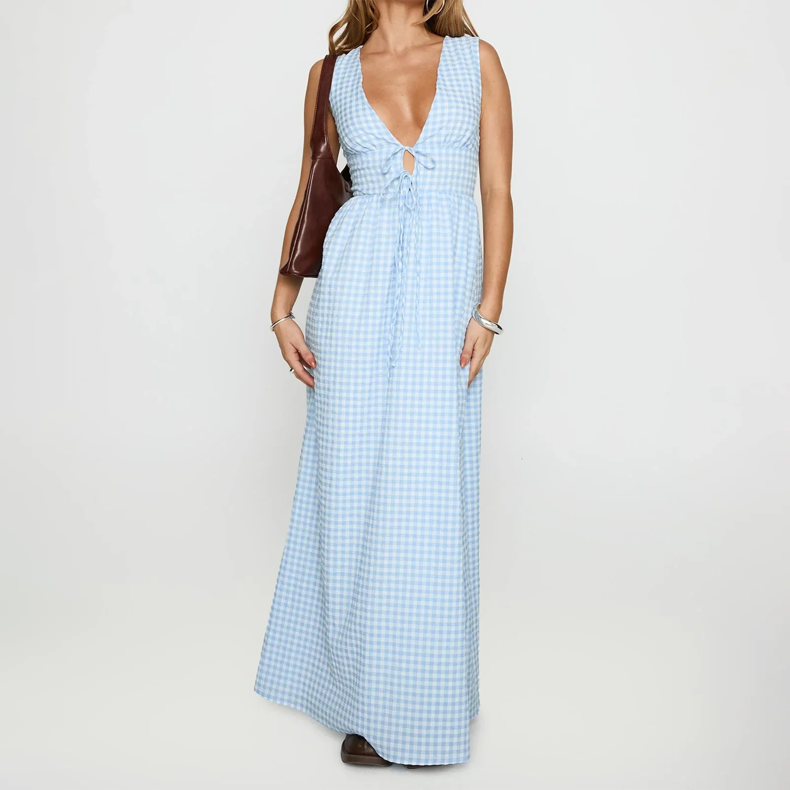 Woman wearing a light blue checkered dress on a white background