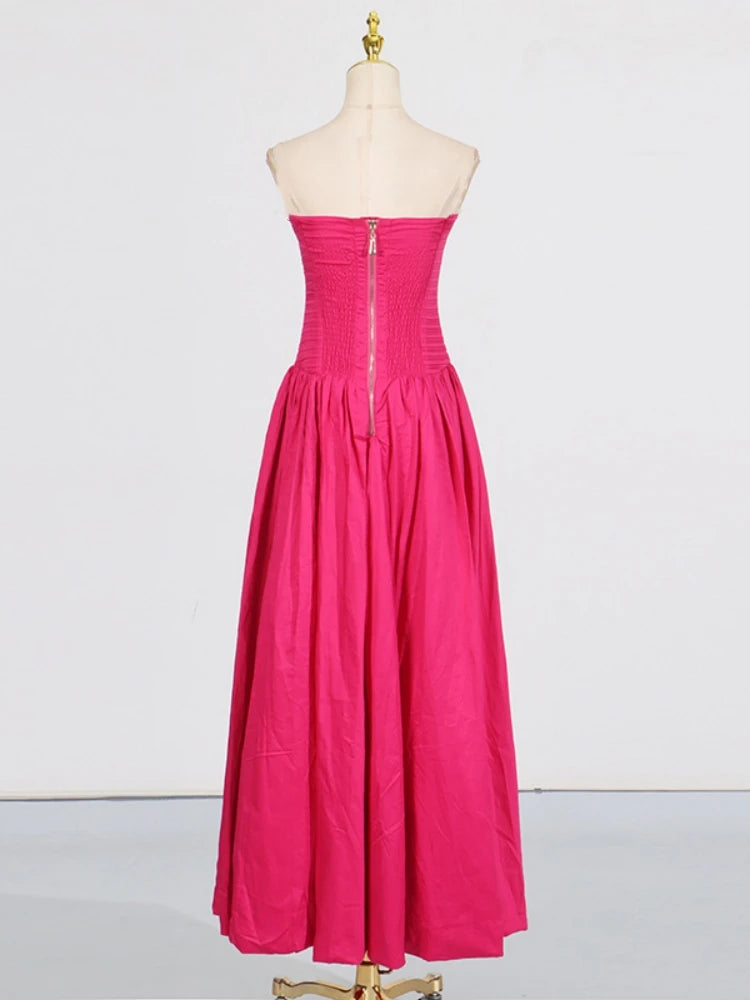 Pink strapless dress on a mannequin against a white background