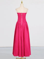 Pink strapless dress on a mannequin against a white background