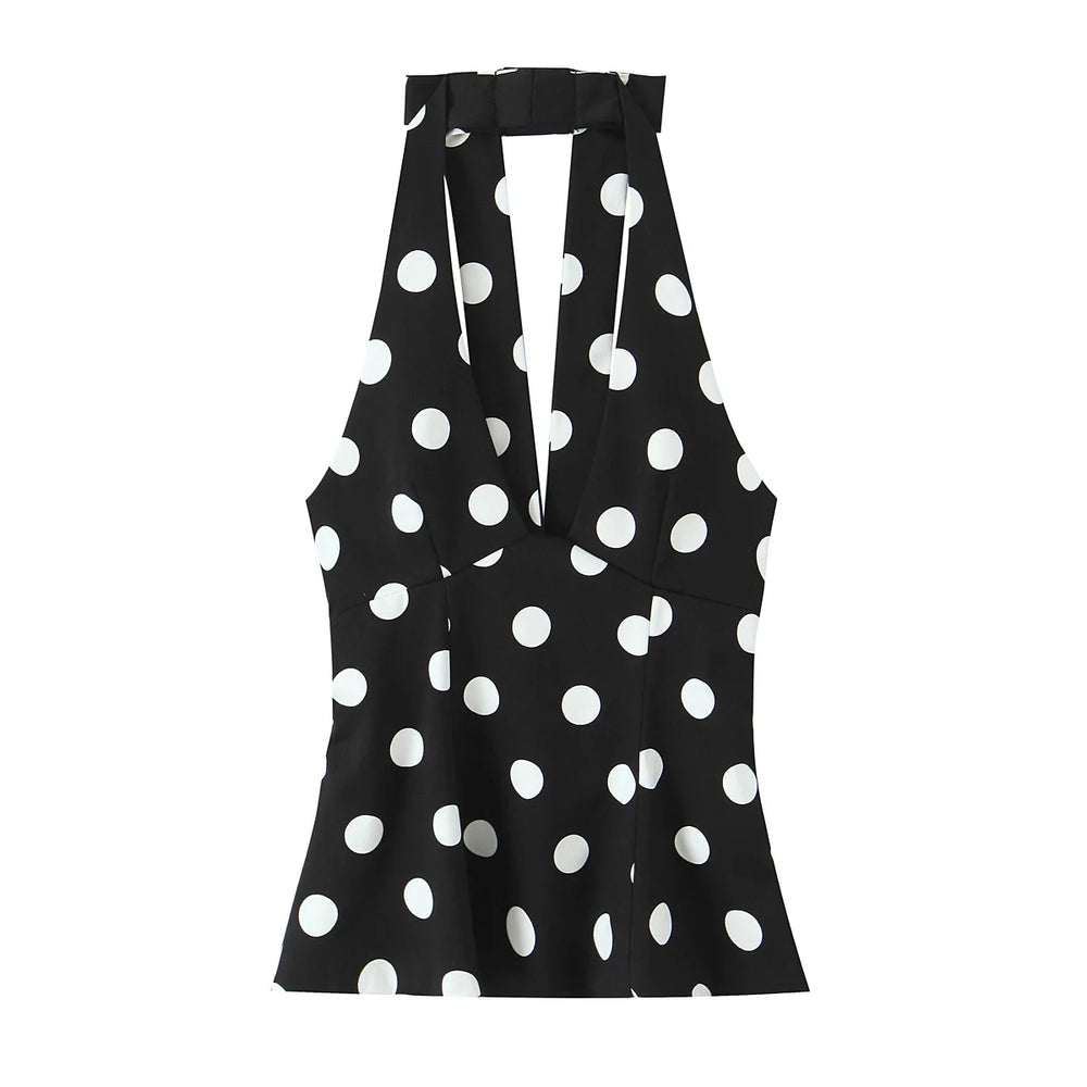 Black sleeveless top with white polka dot pattern on a white background