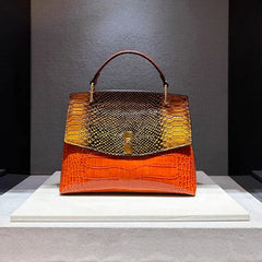 Orange embossed leather satchel bag with snake print flap