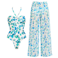 White one-piece swimsuit with abstract blue and green dots and matching wide-leg pants.