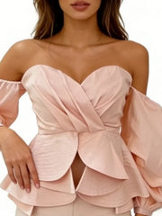 Pink off-shoulder top with layered design on a white background