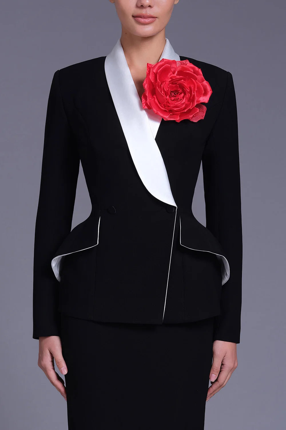 Peplum blazer with contrast lapel and red flower brooch