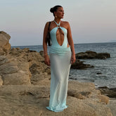 Monochrome one-piece swimsuit with maxi skirt on rocky beach