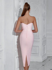 Woman wearing a pink strapless dress in an elegant interior setting