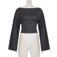 Black polka dot blouse on a mannequin against a white background